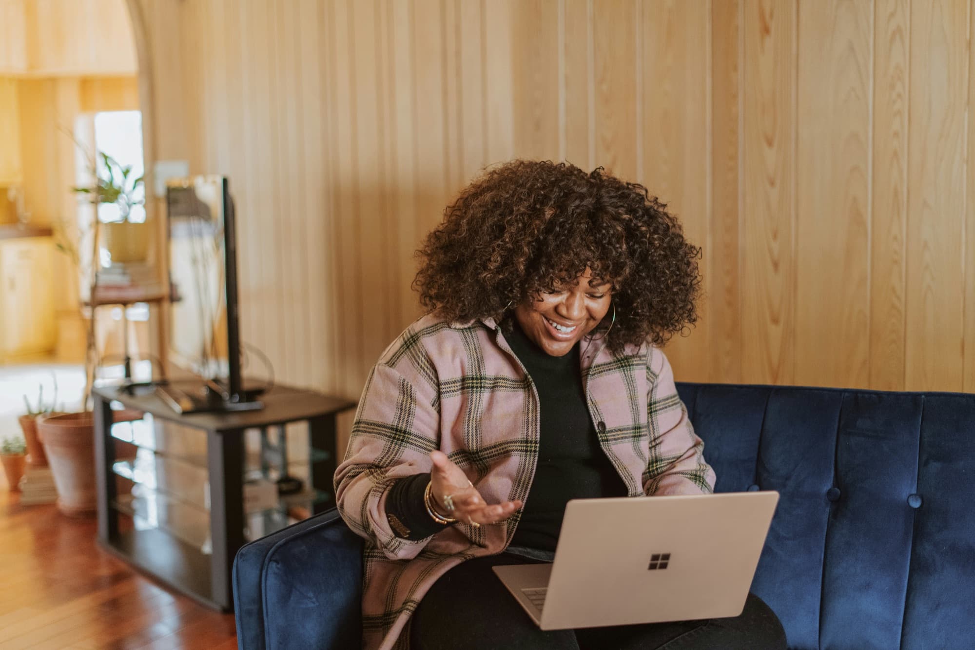 An adult laughing during a video call