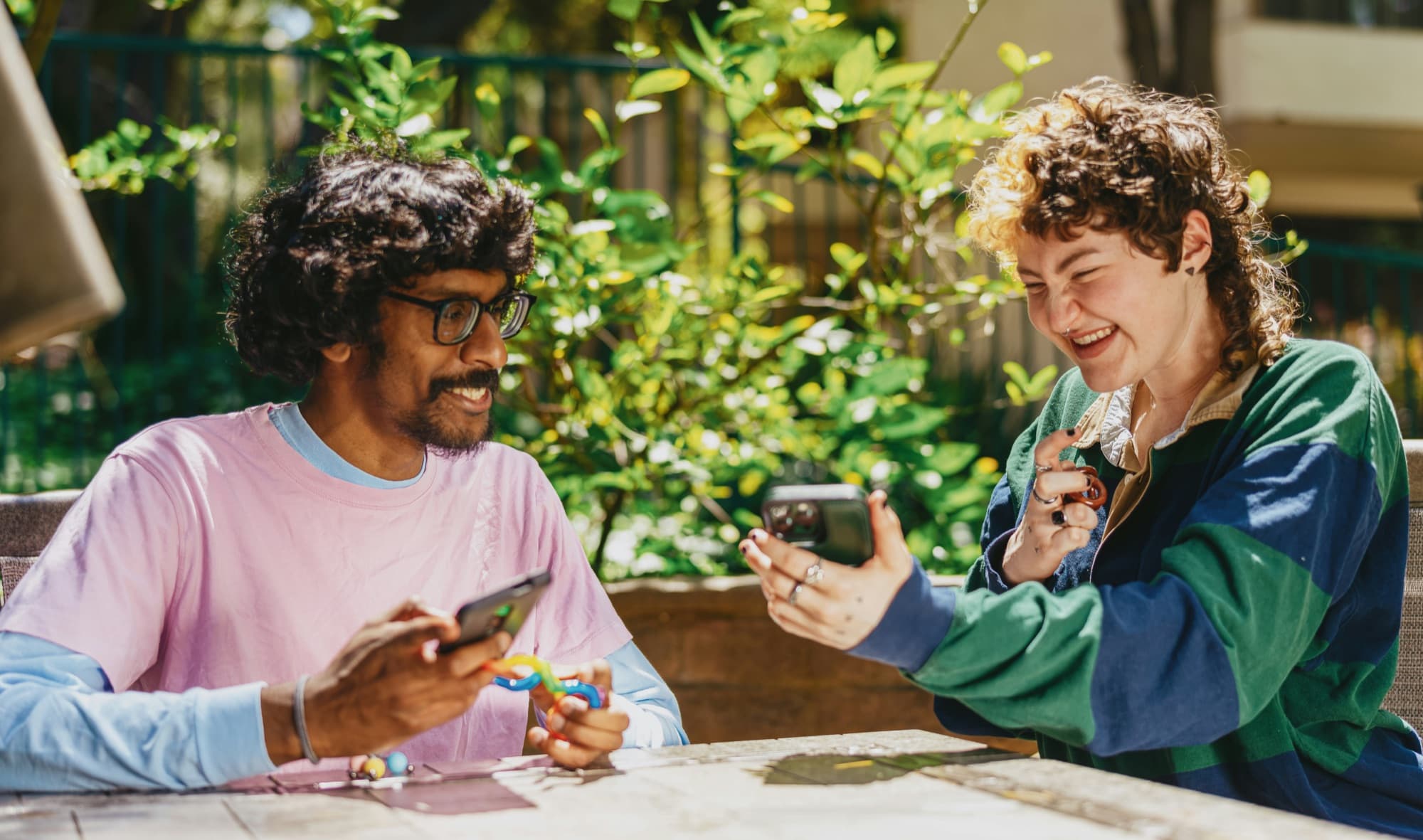 Two friends laughing together outdoors